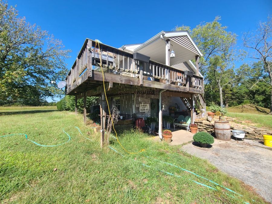 Weathered wood deck on tall posts before it was torn out and rebuilt